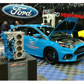 The Ford "EcoBeast" engine in front of the 2016 Ford Focus RS