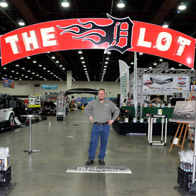 Murray Pfaff stands behind The D Lot sign before Detroit Autorama opened Feb. 26