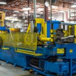 Among the extravagantly large machines energetically pumping out products is an industrial mandrel bender that bends tubing at