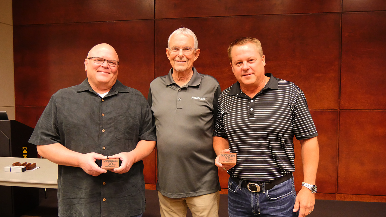 Stillwater Designs employees Bill Doering (left) and Jay Ralston (right) received their 30-year service awards from President St