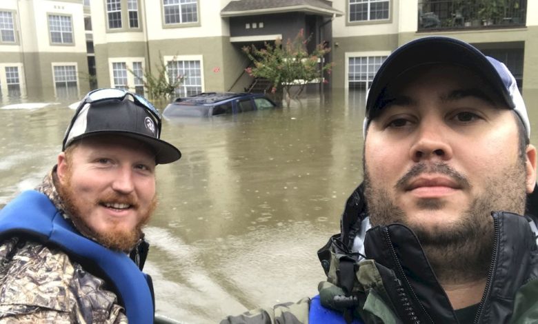 Josh Herzing (left) and another volunteer take a buddy shot while on a day-long mission near Houston
