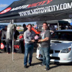 Patrick Utt, owner of RaceQuip, and Brett Kinsfather, vice president of marketing and sales for Motovicity, pose with the Speed