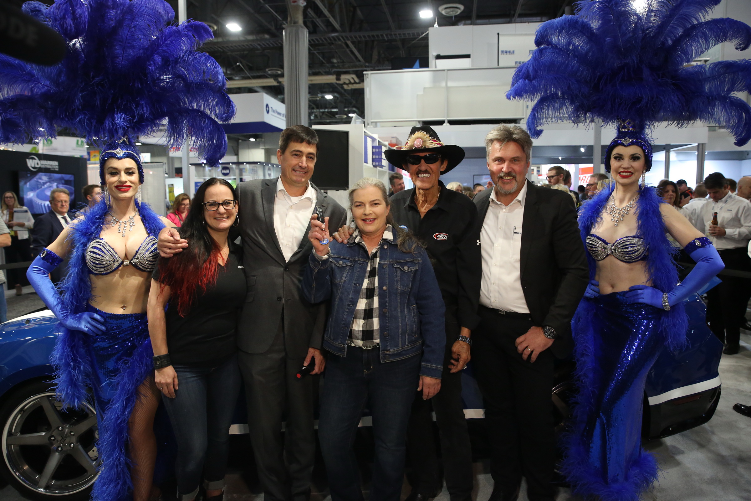 Pictured with two Las Vegas showgirls beside the MAHLE Drive With The Original Technician promotion grand prize MAHLE Mustang bu