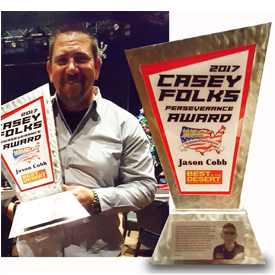 Jason Cobb stands with the Casey Folks Perseverance Award (left). The award is pictured in greater detail on the righthand side