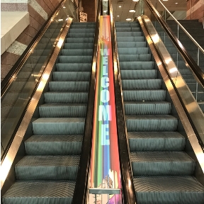 An escalator wrapped by Jeffrey Chudoff of FASTSIGNS. The United States Sign Council commissioned the install on the escalator a