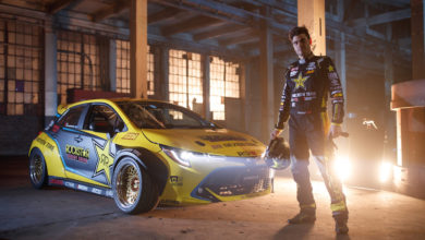 Fredric Aasbo stands with his 2019 Toyota Corolla hatchback Champion Formula DRIFT car