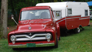 Vintage truck towing a matching travel trailer