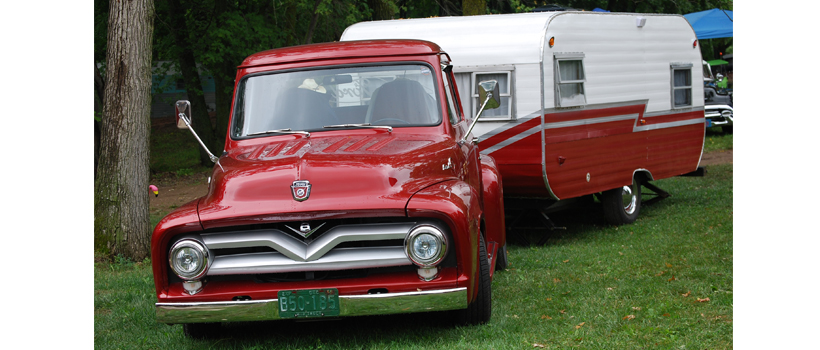 Vintage truck towing a matching travel trailer