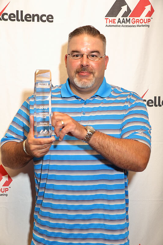 Bennett Jackson of Husky Liners accepts the AAM Group Shipping Excellence Award.