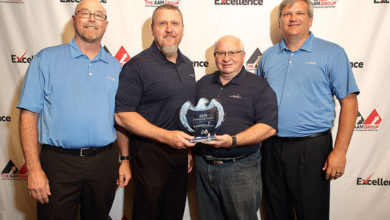 Lund accepts the AAM Group Partnership Award. From L to R: Tim Henggeler, Bob Christian, Jim Gartner, and Travis Shirley