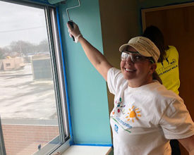 A PPG volunteer helps with family lounge revitalization efforts at Laura's Home in Cleveland.