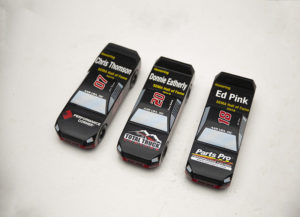 The AAM Group has bought and built three pinewood derby trucks to benefit the SEMA Cares charitable organization.