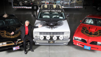 Burt Reynolds poses with three out of four cars going to auction Sept. 29 at a Las Vegas Barrett-Jackson event