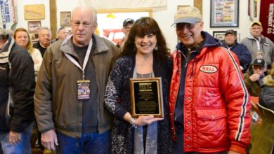 Donna Garlits, center, was presented with an award by Bruce Larson, right, and Dick Gerwer, left.