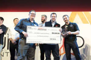 The SEMA Launch Pad winner Matt Beenen (center) of Builtright Industries was presented his check by YEN Chairman Rory Connell (l