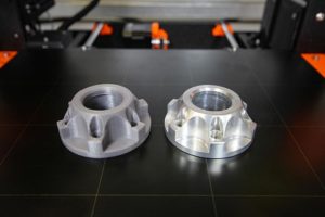 3D Printed Part, left, CNC Aluminum Part, right. Photo by Michael Barbalinardo