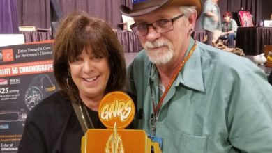 Deb Pollack, director of Drive Toward a Cure, poses with a pinstriping artist who created a custom Grand National Roadster Show