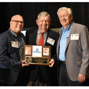Donny Braga (left),Â Permatex senior marketing manager, accepts the Allison Family Corporate Award from Donnie Allison (center) a