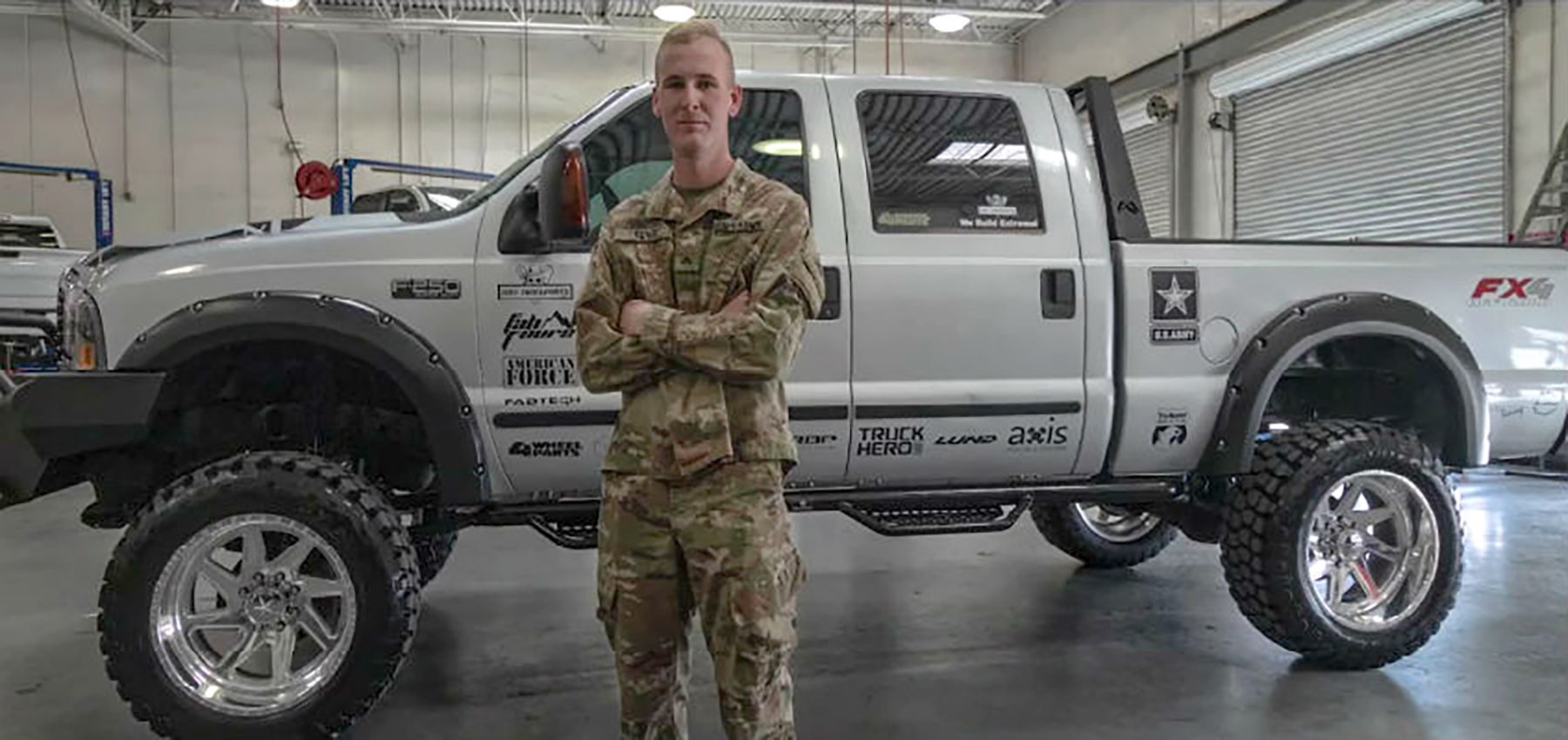 U.S. Army Cpl. James Wesley Trent standing in front of his new and fully customized Ford F-250 Super Duty