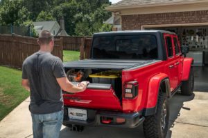 The Armis Hard Folding Bed Cover for Jeep Gladiator features a tri-fold design and LINE-X coating.