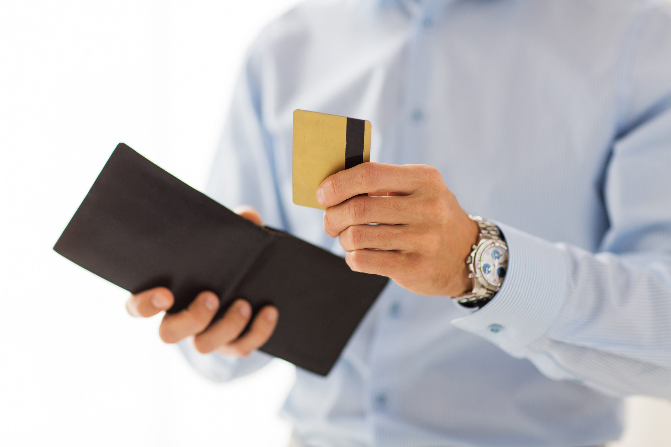 people, business, finances and money concept - close up of businessman hands holding open holding wallet and credit card