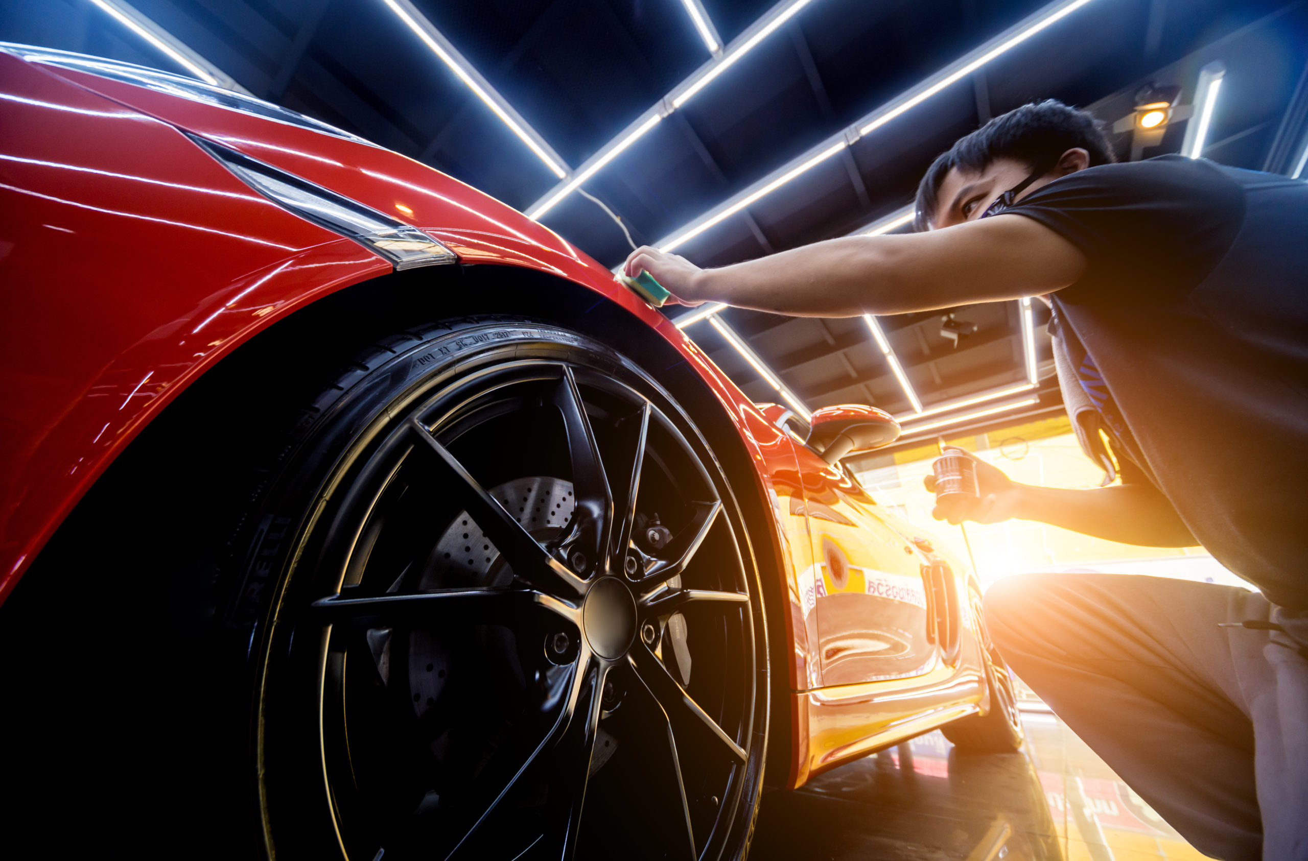 Car service worker applying nano coating on a car detail. Tools for polishing