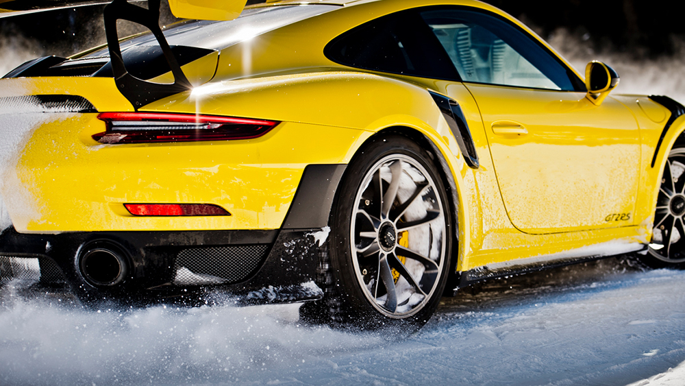 Yellow Porsche racing on ice