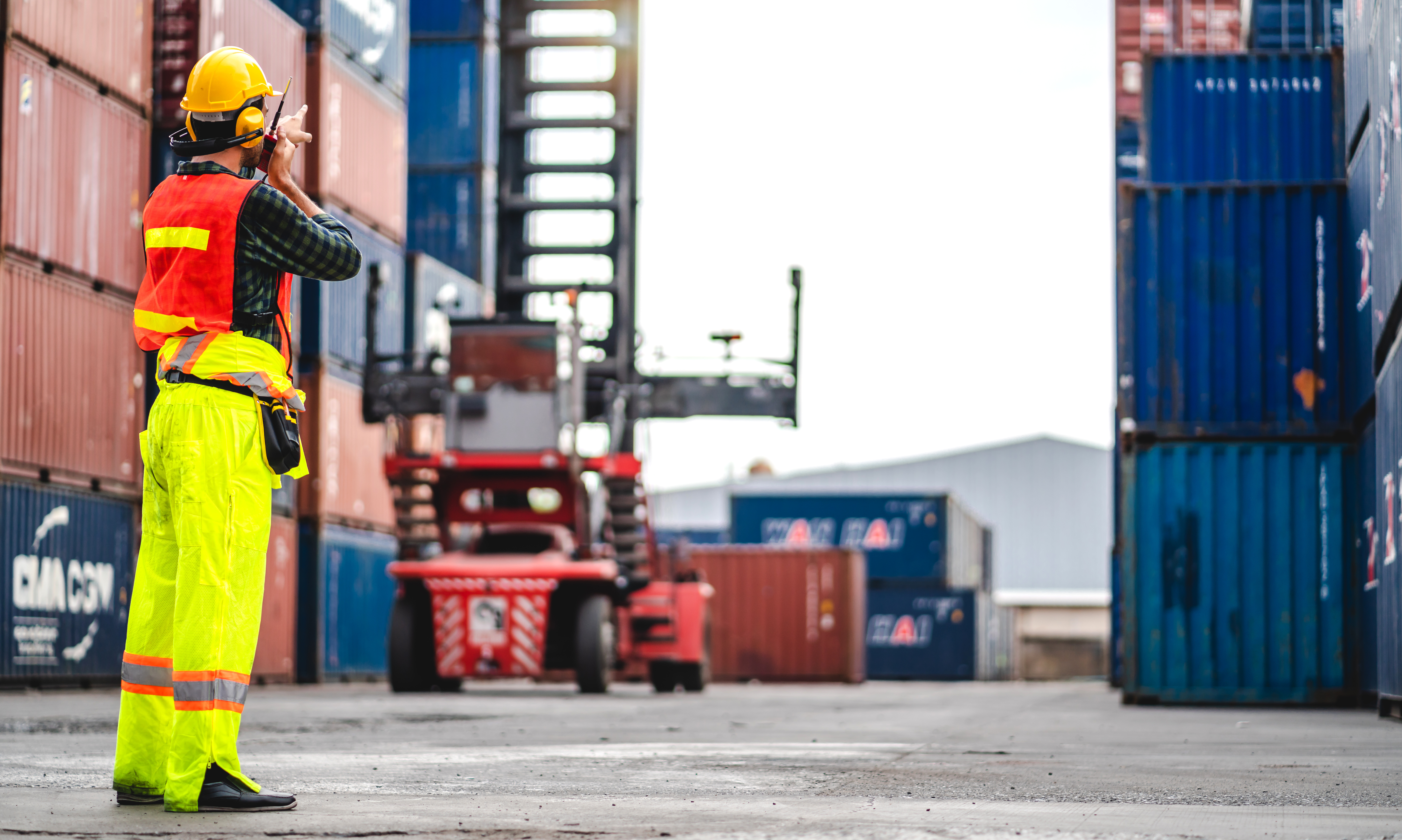 Professional engineer container cargo foreman in helmets working