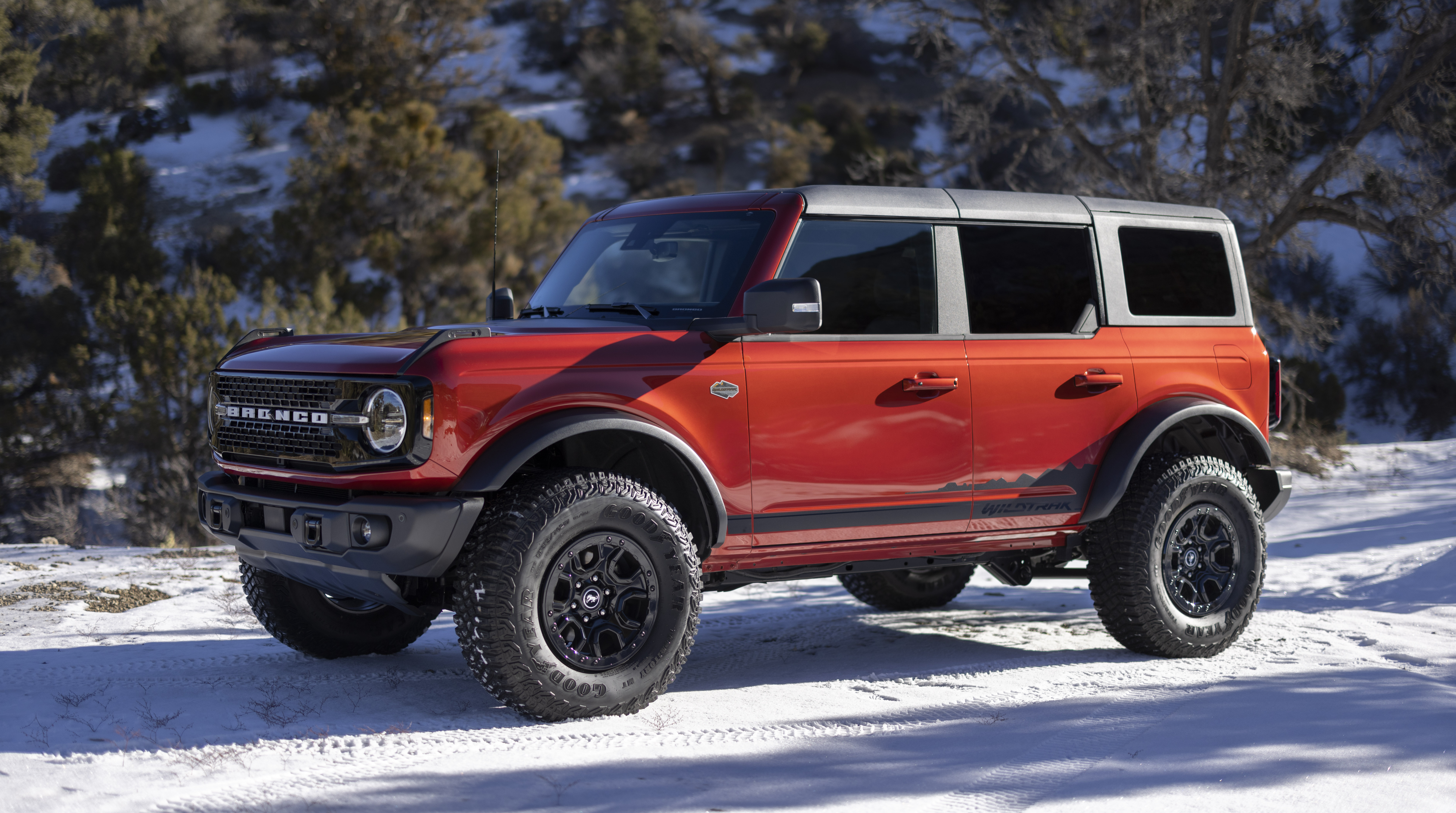 Red Ford Bronco on snowy road