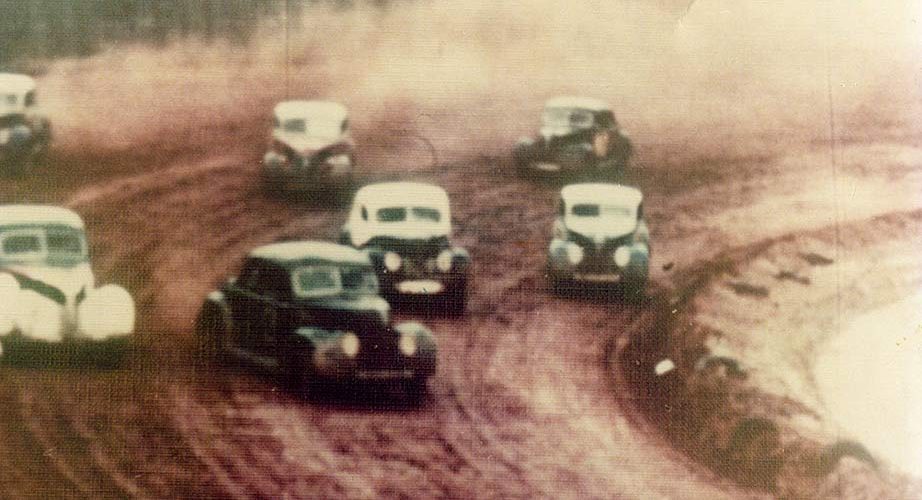 old cars racing on dirt track