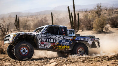 trophy truck racing off-road through desert