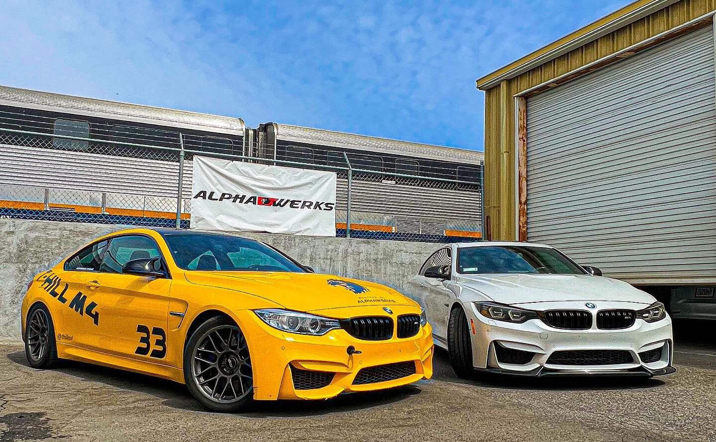 two cars parked in front of a garage