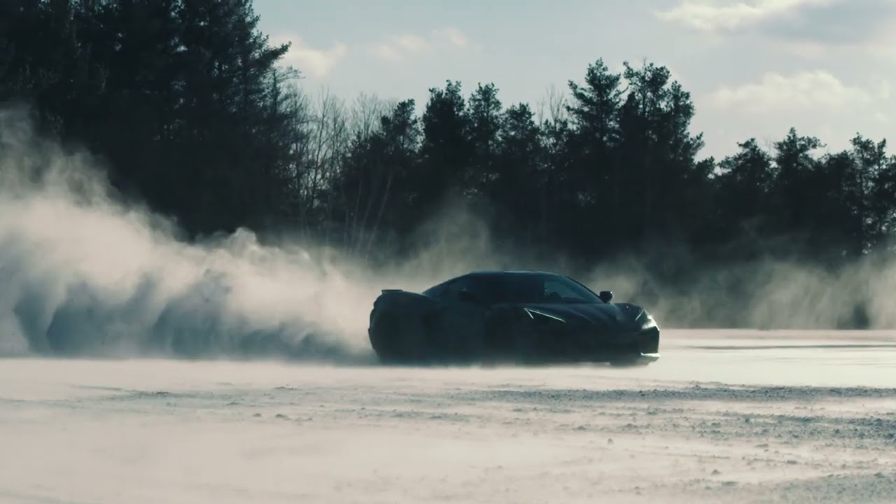 sports car driving across snow