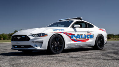 a mustang police cruiser sitting on the road