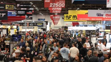 SEMA Show attendees walking a crowded show floor.