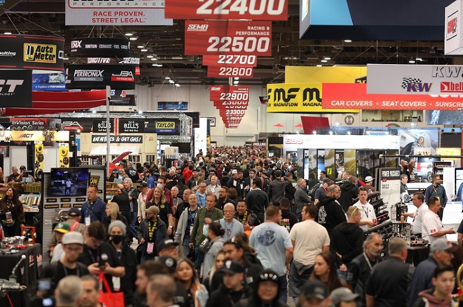 SEMA Show attendees walking a crowded show floor.