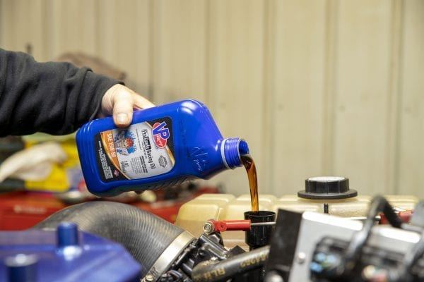 Blue VP Oil bottle pour into engine