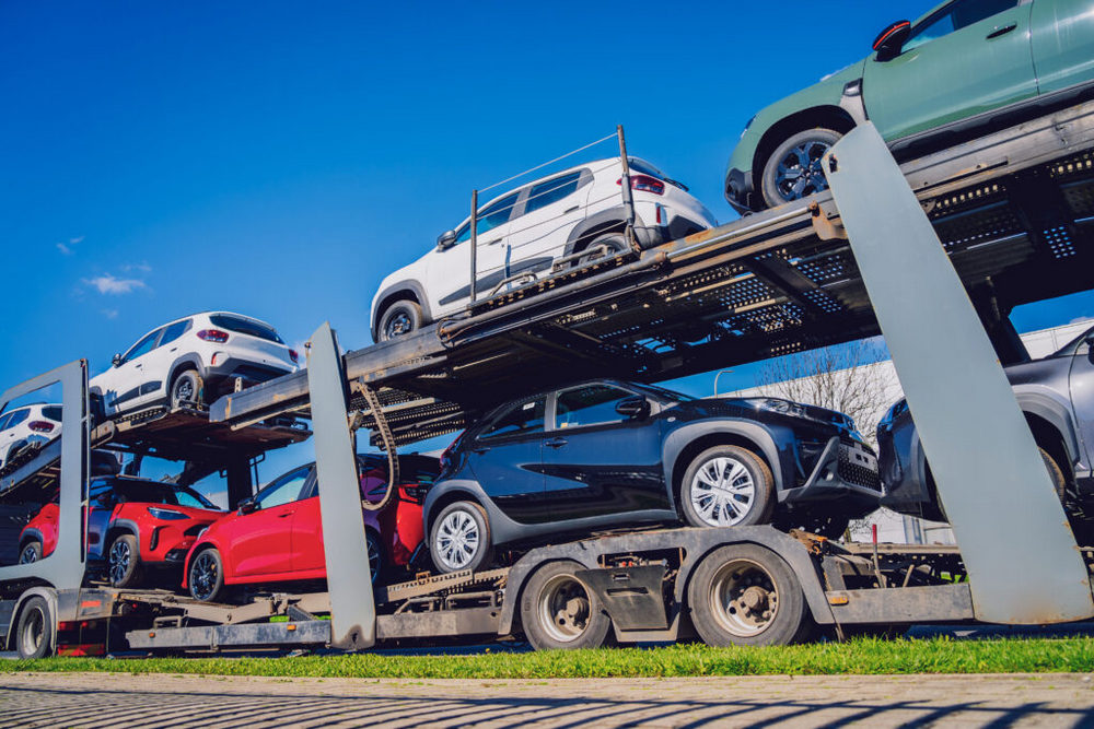 Vehicles loaded on 2-deck car transport trailer