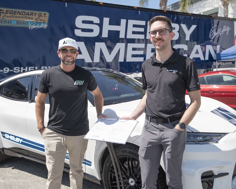 Rob Ward and Mavrick Knoles stand in front of a Shelby EV
