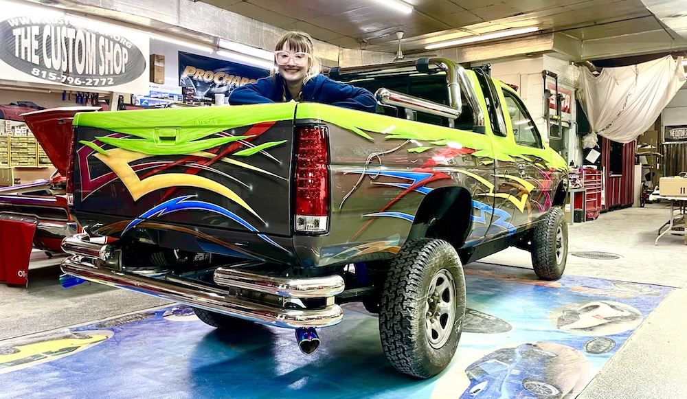 Custom sShop multi-colored truck with Bri Wargo in the truck bed