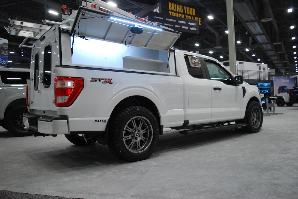 White Ford pickup with utility truck cap at 2023 SEMA Show