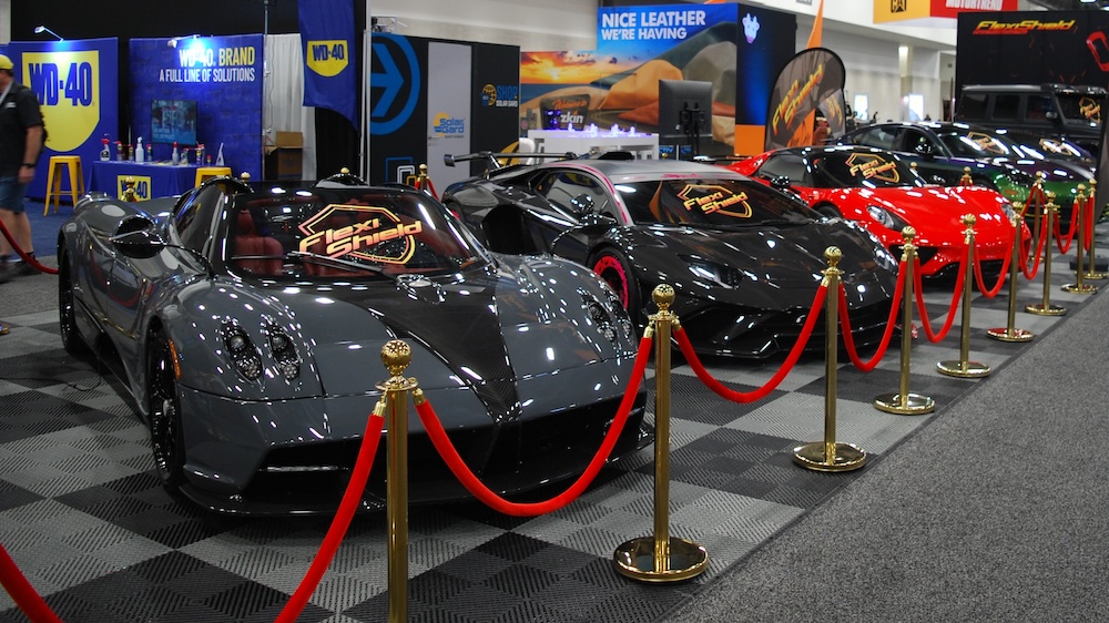 Luxury cars in Flexi-Shield booth at SEMA