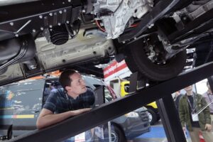 Work Truck Week attendee checks out truck undercarriage