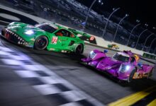 Race cars approaching finish line on racetrack