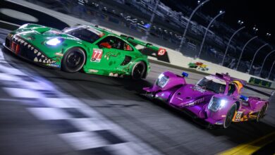 Race cars approaching finish line on racetrack