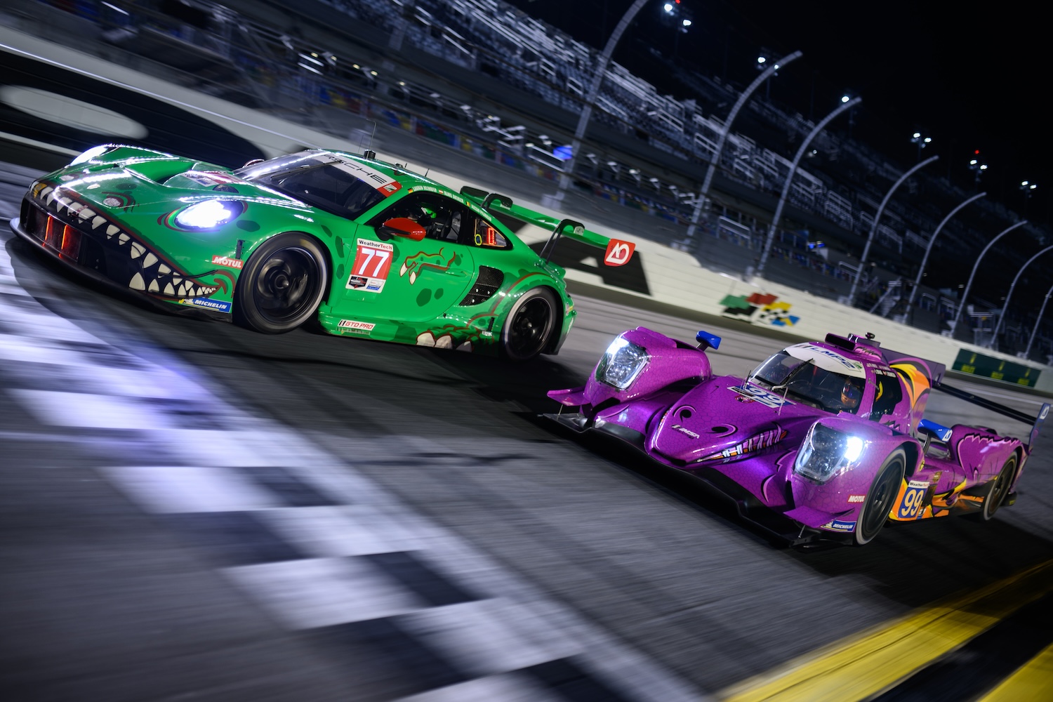 Race cars approaching finish line on racetrack