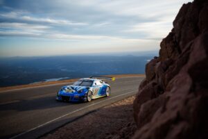 chen photo sports car on road above ocean