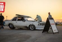 Racers working on car for HOT ROD Drag Week