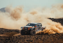 Truck racing in desert at Dakar Rally