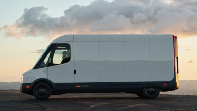 Side view of the Rivian Commercial Van parked in front of sunset